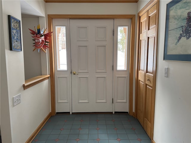 entrance foyer with baseboards and a wealth of natural light