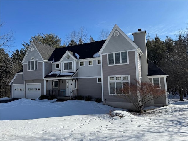 view of front of house featuring covered porch, a chimney, and an attached garage