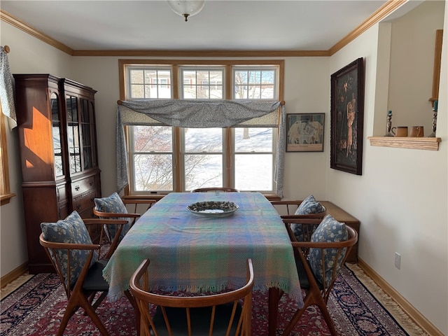 dining area featuring baseboards and crown molding