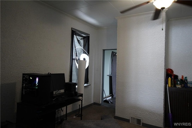 hallway with baseboards, visible vents, crown molding, and a textured wall