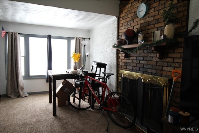 carpeted dining area featuring a brick fireplace and a textured wall