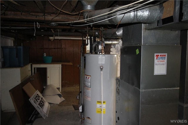 utility room featuring heating unit and water heater