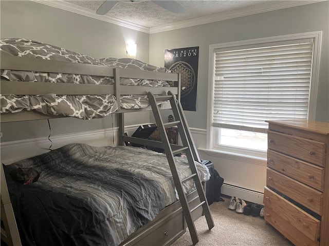 bedroom with a textured ceiling, ceiling fan, a baseboard heating unit, carpet floors, and crown molding