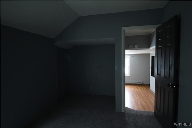 interior space with a baseboard radiator and vaulted ceiling