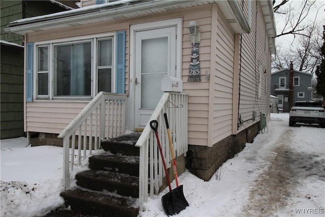 view of snow covered property entrance