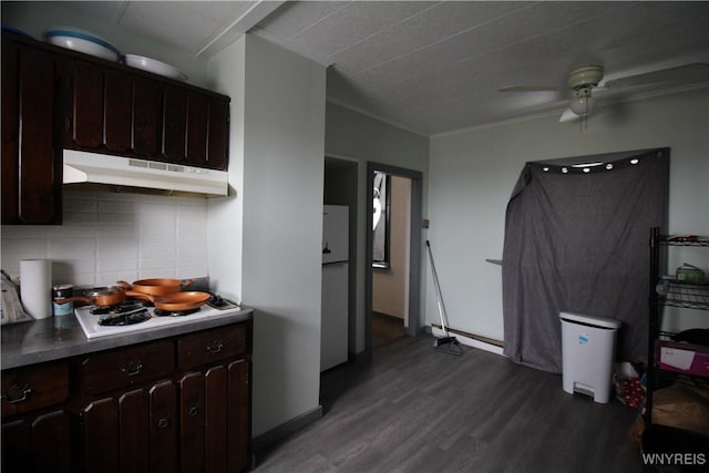 kitchen with dark wood finished floors, decorative backsplash, white gas cooktop, dark brown cabinets, and under cabinet range hood