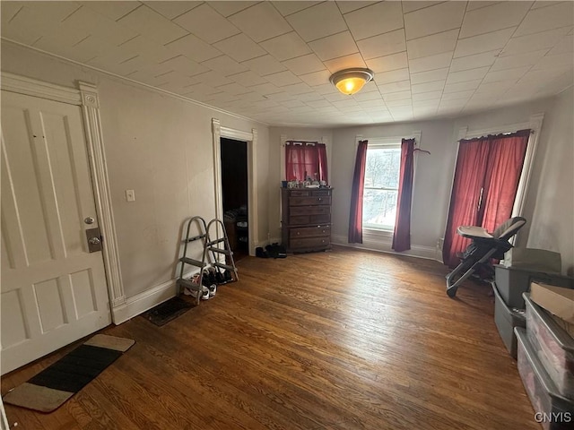 interior space with baseboards and wood finished floors