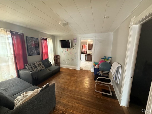 living area with wood finished floors and baseboards