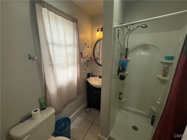 bathroom with toilet, a stall shower, a sink, and tile patterned floors