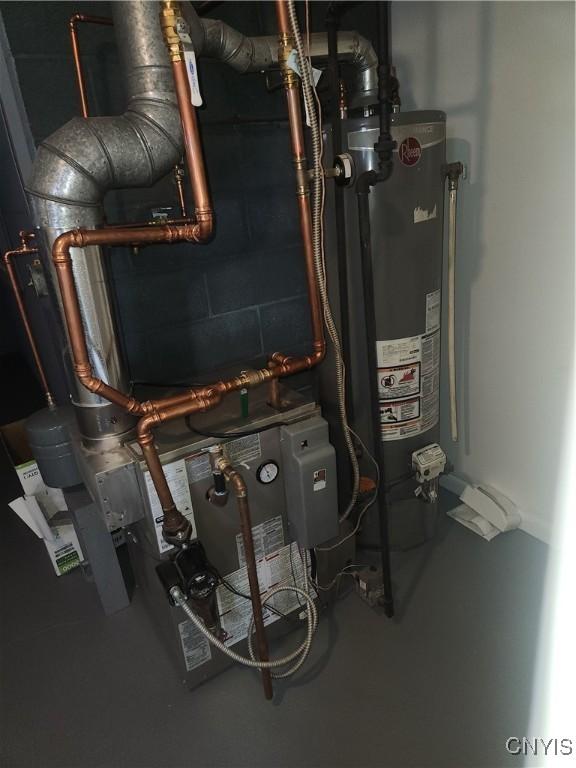 utility room featuring water heater