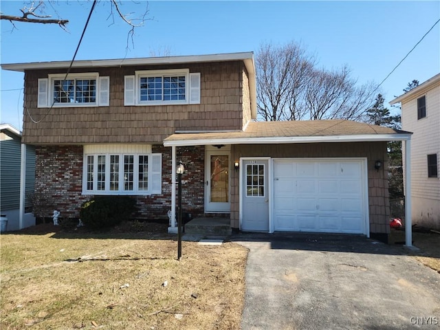 view of front of house featuring aphalt driveway, a front lawn, brick siding, and an attached garage