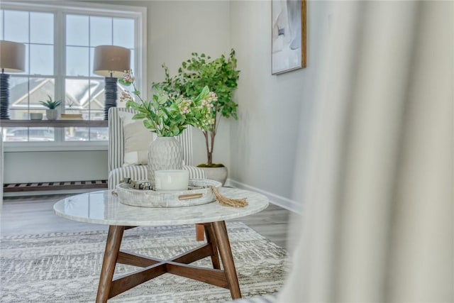 living area featuring baseboards and wood finished floors