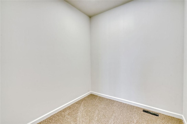 carpeted spare room with baseboards