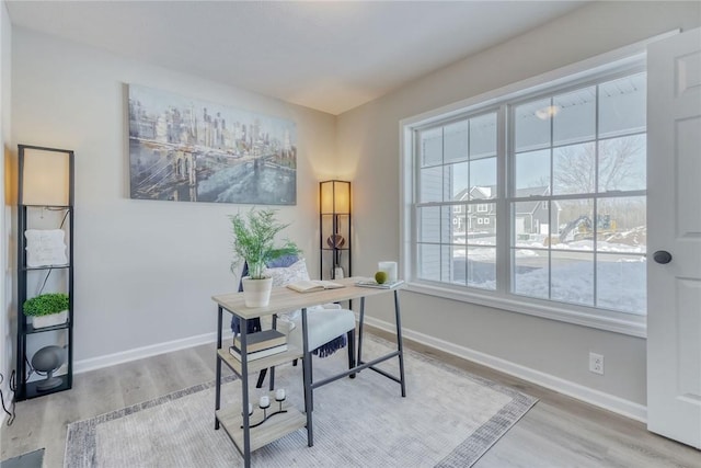 office featuring baseboards and light wood-style floors