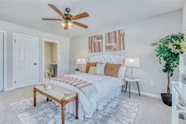 bedroom with ensuite bathroom, carpet, a ceiling fan, and baseboards