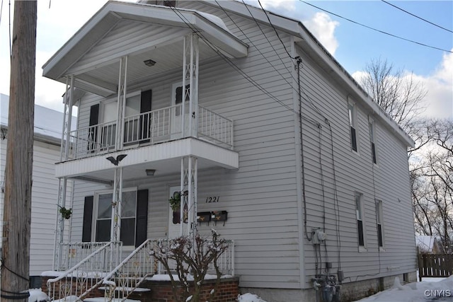 view of front of property with covered porch and a balcony