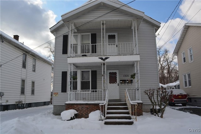 view of front facade with a porch and a balcony