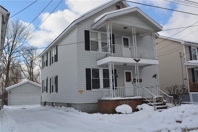 view of front of home with a balcony, covered porch, a garage, and an outdoor structure