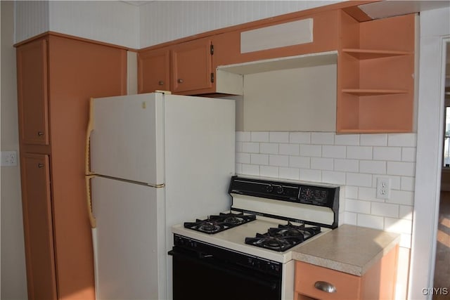 kitchen featuring light countertops, white appliances, and backsplash