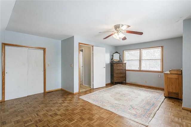 unfurnished bedroom featuring ceiling fan, a closet, and baseboards