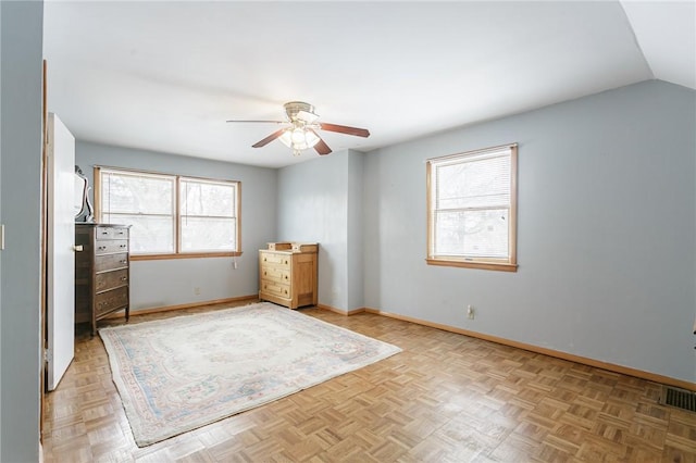 unfurnished bedroom featuring vaulted ceiling, ceiling fan, visible vents, and baseboards