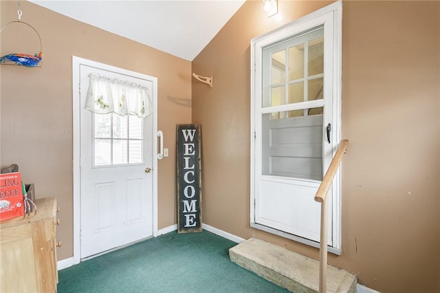 doorway to outside featuring carpet floors and baseboards