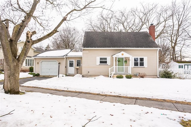 bungalow-style house featuring an attached garage and a chimney