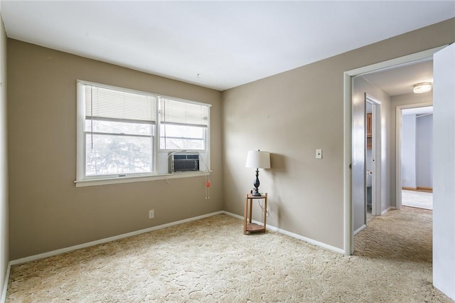 carpeted spare room with baseboards