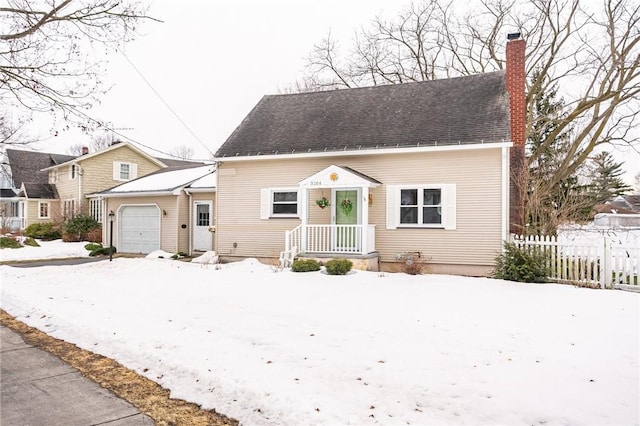 bungalow-style home with an attached garage, a shingled roof, a chimney, and fence