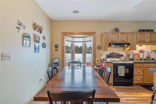 dining room featuring visible vents and light wood-style floors