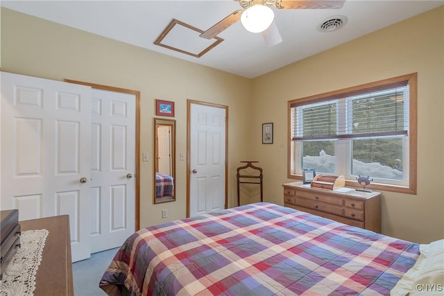 bedroom featuring visible vents, carpet floors, and a ceiling fan