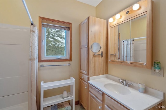 bathroom featuring curtained shower and vanity
