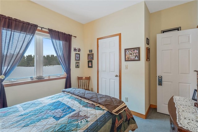 bedroom featuring carpet and baseboards