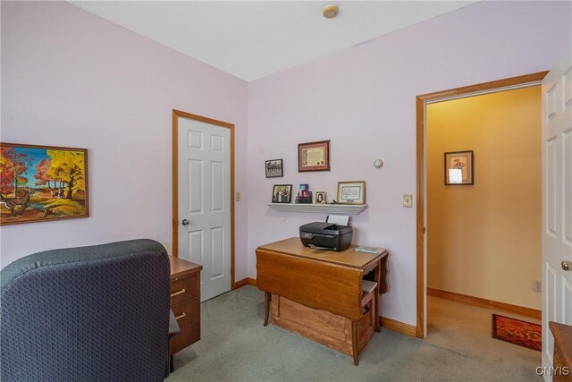 carpeted home office with baseboards