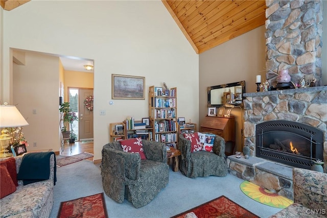 carpeted living area with a stone fireplace, wooden ceiling, and high vaulted ceiling
