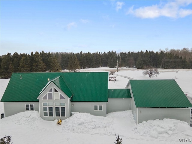 view of front of house with a forest view and metal roof