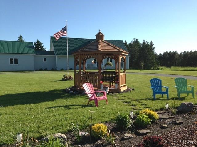 view of jungle gym featuring a gazebo and a lawn