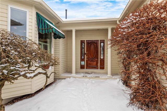 view of snow covered property entrance