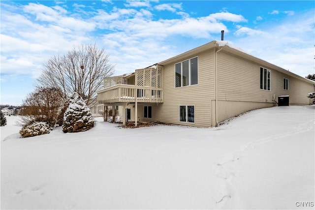 snow covered property featuring cooling unit