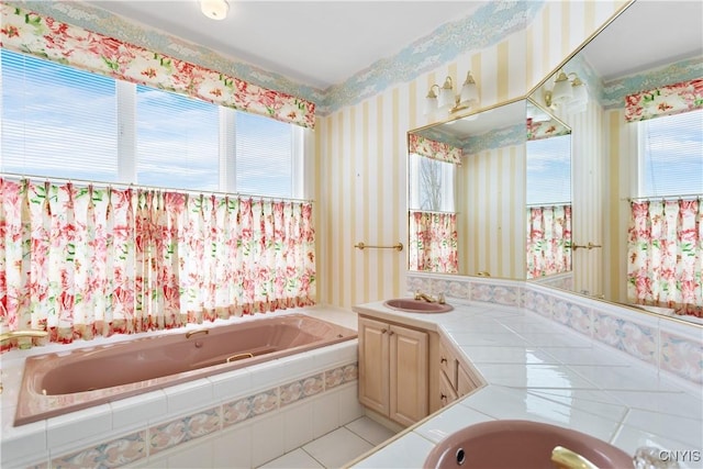 full bath featuring wallpapered walls, a garden tub, and vanity