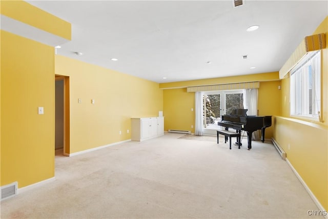 living area with baseboards, visible vents, baseboard heating, and light colored carpet