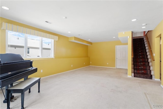 living area with baseboards, stairs, visible vents, and light colored carpet