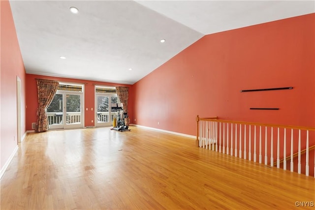 interior space with lofted ceiling, recessed lighting, wood finished floors, and baseboards