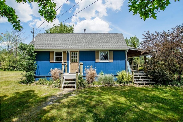 view of front of home with a front lawn and roof with shingles