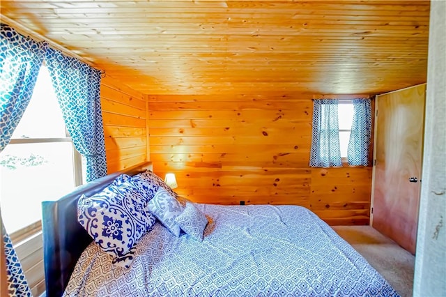 carpeted bedroom with wooden ceiling and wooden walls