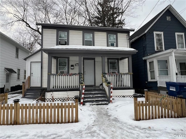 view of front of house with a porch and fence