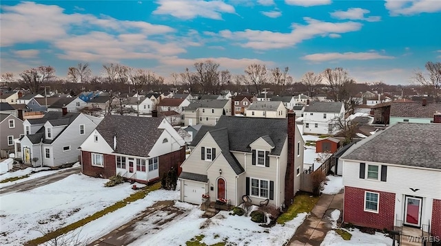 snowy aerial view featuring a residential view