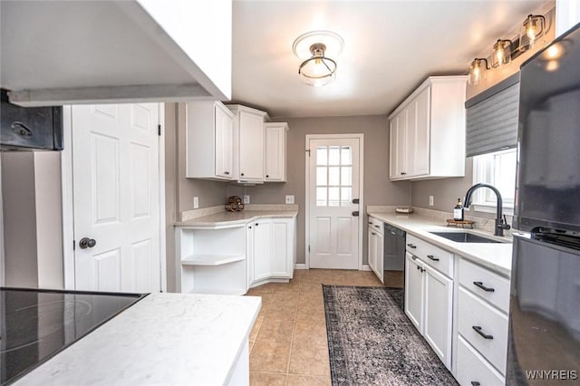 kitchen featuring light countertops, white cabinets, a sink, and black appliances