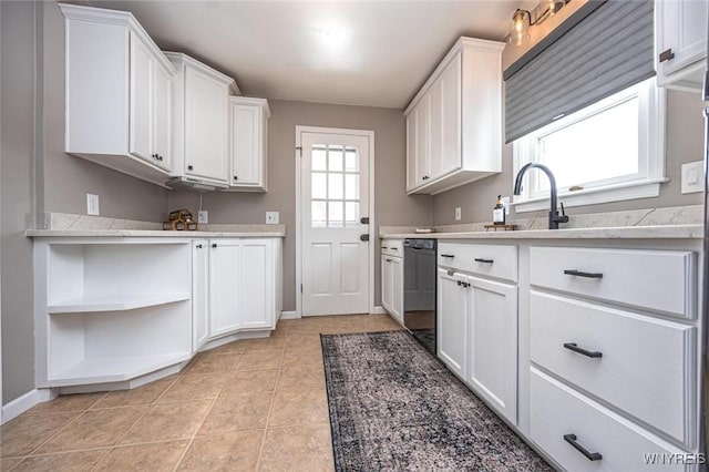 kitchen with white cabinets, light countertops, dishwasher, and light tile patterned floors