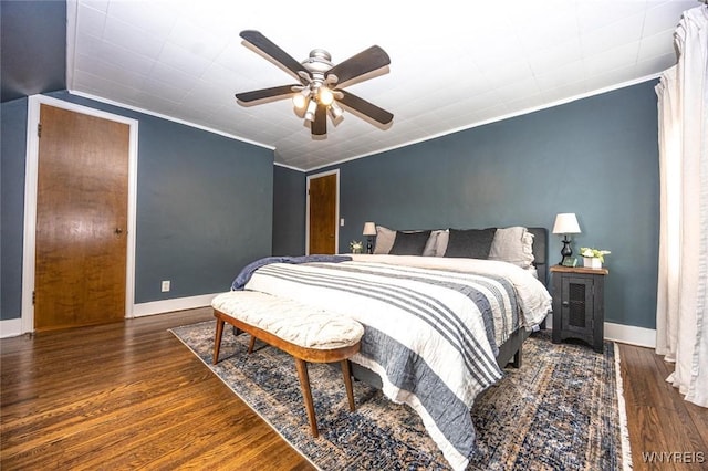 bedroom featuring a ceiling fan, baseboards, ornamental molding, and wood finished floors